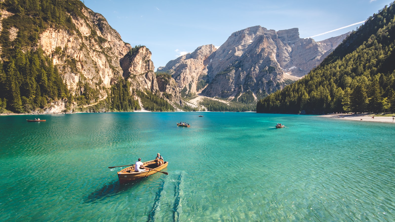 A scenic coastal viewpoint with a winding road and clear blue water below