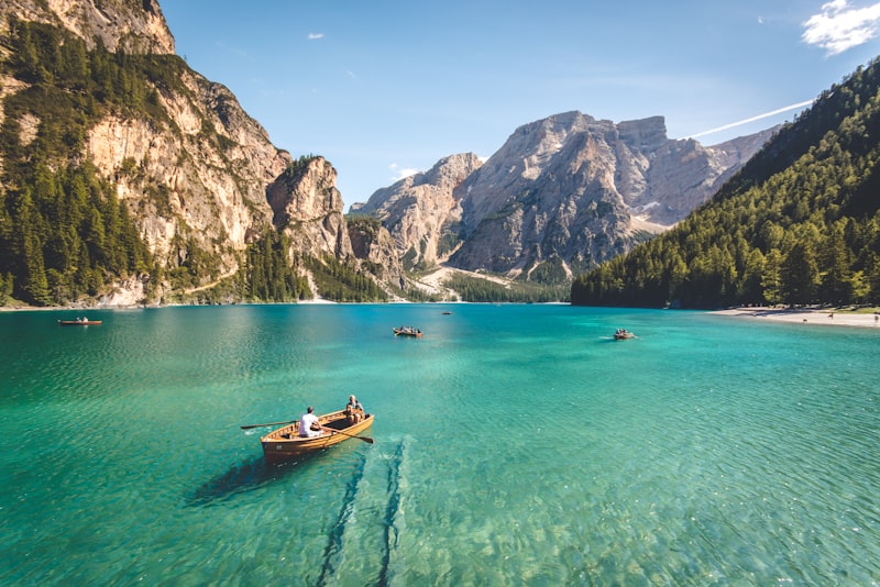 A scenic coastal viewpoint with a winding road and clear blue water below